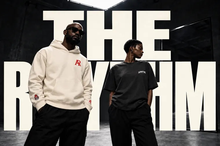Algorhythm — THE RHYTHM behind a man in the cream red AR hoodie and a woman in the charcoal SIGNAL tee